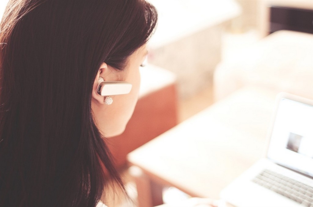 girl using blutooth earphone 2